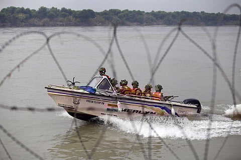 BSF soldiers patrol on a boat in river Chenab at Pargwal area along the India Pakistan border in Jammu district. (Photo | PTI)