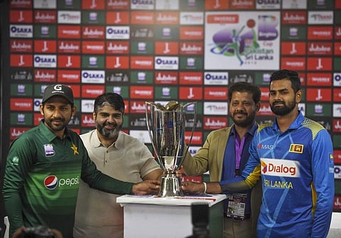 Pakistan's team captain Sarfaraz Ahmed (L) holds the ODI trophy along with Sri Lanka's captain Lahiru Thirimanne (R) during a ceremony at the National stadium in Karachi. (Photo | AFP)