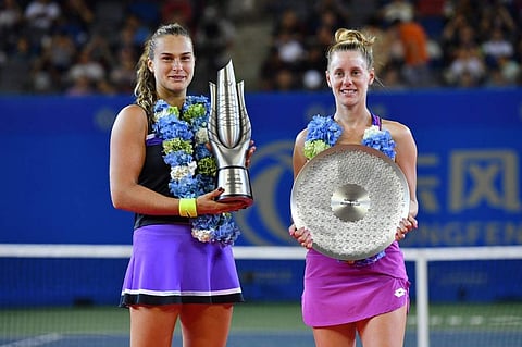 Aryna Sabalenka of Belarus (L) poses with the winner's trophy alongside runner-up Alison Riske of the US (R) after their women's singles final match at the Wuhan Open tennis tournament in Wuhan. (Photo | AFP)