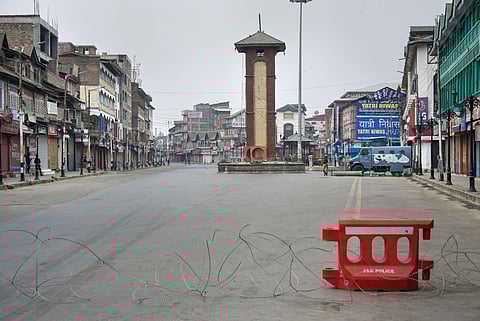 Security personnel install concertina wire to block a road during restrictions in Srinagar Friday Sept. 27 2019. | (Photo | PTI)