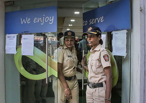 Mumbai Police personnel stand guard outside Punjab and Maharashtra Cooperative Bank PMC at GTB Nagar in Mumbai. (Photo | PTI)