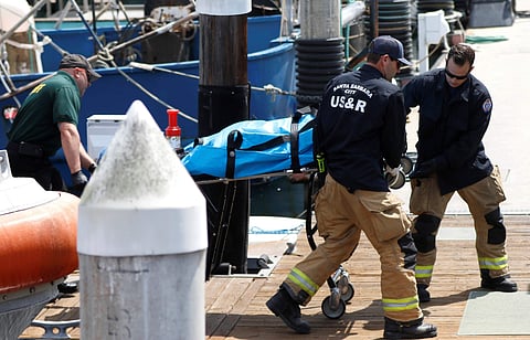 Santa Barbara City Search and Rescue along with Santa Barbara Sheriff's officers move a recovered body on the dock at Santa Barbara Harbor in Santa Barbara. (Photo | AP)
