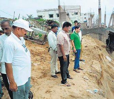 Collector Vijay Amrut Kulange inspecting damaged toilet complex site at Gopalpur on Monday (Photo | EPS)