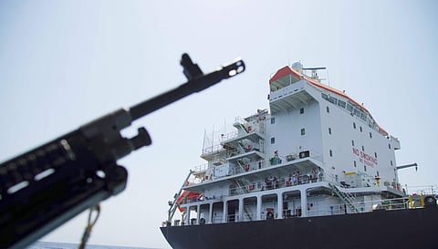 In this June 19, 2019 file photo, sailors stand on deck above a hole the U.S. Navy says was made by a limpet mine on the damaged Panama-flagged, Japanese owned oil tanker Kokuka Courageous, anchored off Fujairah, UAE, during a trip organized by the Navy f