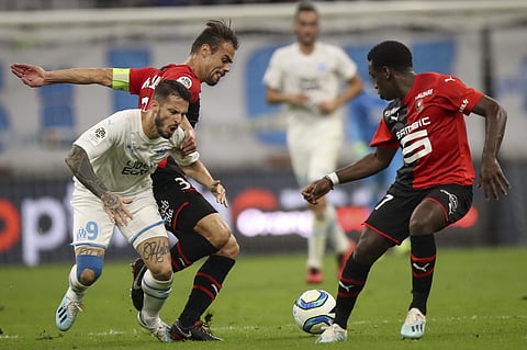 Marseille's Dario Benedetto collides with Rennes' Damien Da Silva. (Photo | AP)