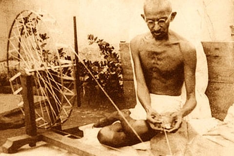 Mahatma Gandhi with his charkha (Image courtesy Wikimedia Commons)