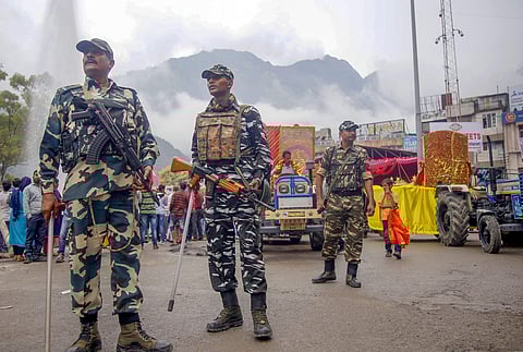 CRPF soldiers stand guard during a procession on the the first day of Navratri festival at Katra about 45 kms from Jammu Sunday Sept. 29 2019. | (Photo | PTI)