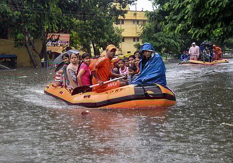 State Disaster Response Force SDRF workers rescue people from flood-affected area of Bahadurpur following heavy monsoon rainfall in Patna. (Photo | PTI)