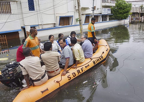 Bihar Deputy CM Sushil Kumar Modi (extreme right in grey shirt) and his family members being rescued by a SDRF team from his flooded residence at Rajendra Nagar in Patna on Monday. (Photo | PTI)