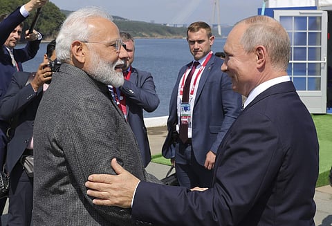 Russian President Vladimir Putin, right, and Indian Prime Minister Narendra Modi shake hands during their meeting ahead of the Eastern Economic Forum at the Russky Island. (Photo | AP)
