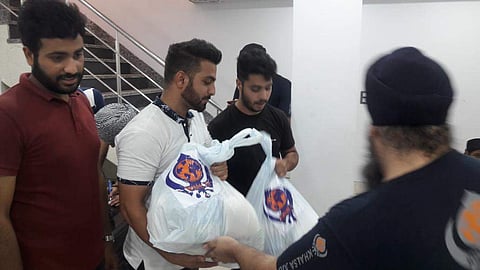 Volunteers of J&K Association with Khalsa Aid distribute stock, groceries, money among Kashmiri Students (Photo | Twitter/ @NasirKhuehami)