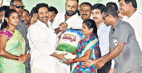 Chief Minister Jagan Mohan Reddy distributing rice bags during the launch of quality rice scheme as a pilot project at Palasa in Srikakulam district on Friday | Express