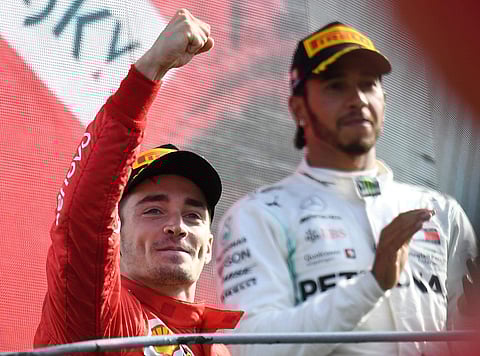 Ferrari driver Charles Leclerc of Monaco, left, celebrates with third placed Mercedes driver Lewis Hamilton of Britain, on podium after winning the Formula One Italy Grand Prix at the Monza racetrack, in Monza, Italy, Sunday, Sept.8, 2019. | AP