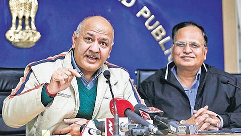 File | Manish Sisodia addresses a press conference with Satyendar Jain
