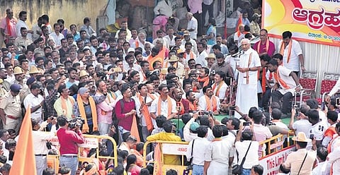 Senior RSS leader Kalladka Prabhakar Bhat addresses the gathering during a protest rally against the proposed Jesus Christ statue in Kanakapura on Monday | express