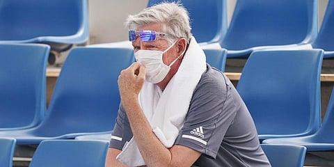 A spectator wears a mask as smoke haze shrouds Melbourne during an Australian Open practice session at Melbourne Park in Australia. (Photo | AP)