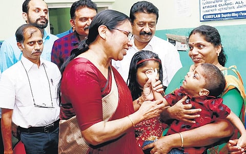 Health Minister K K Shailaja interacts with Ashwin Manu and family at Medical College Hospital | EXPRESS
