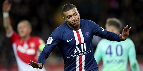 PSG's Kylian Mbappe celebrates after scoring his side's opening goal during the French League One soccer match between Monaco and Paris Saint-Germain at the Louis II stadium in Monaco. (Photo | AP)