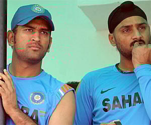 Cricketers Mahendra Singh Dhoni and Harbhajan Singh during the practice session in Guwahati. PTI