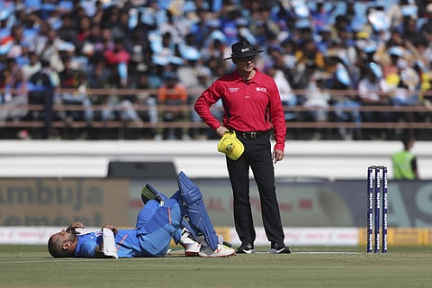 Shikhar Dhawan lies on the ground after being hit. (Photo | AP)