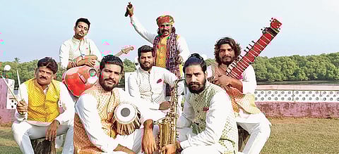 Members of the band Swaraag, all suited up in traditional attire before a performance.