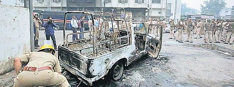 Burned police vehicles outside Tis Hazari court during the clash. (File Photo)
