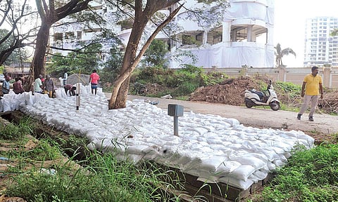 Workers cover the Indian Oil pipeline in front of Holy Faith H2O on Wednesday based on the expert committee’s recommendations to ensure its safety during the implosion | A SANESH