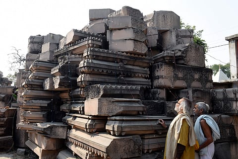 Visitors look at stone slabs carved-out for the construction of Ram Temple at Shri Ram Janmbhoomi Karyashala workshop in Karsewakpuram Ayodhya (File Photo | PTI)
