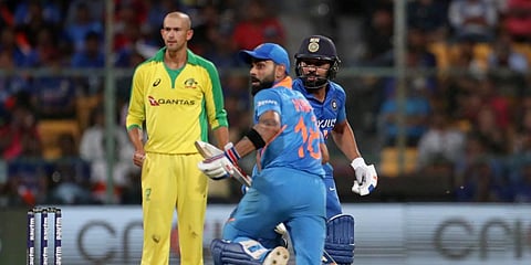 Australia's Ashton Agar, left, watches as India's captain Virat Kohli, center, and Rohit Sharma run between the wickets to score during the third one-day international cricket match between India and Australia in Bangalore. (Photo | AP)