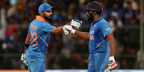 India's Rohit Sharma, right, celebrates with captain Virat Kohli after hitting a boundary during the third one-day international cricket match between India and Australia in Bangalore. (Photo | AP)