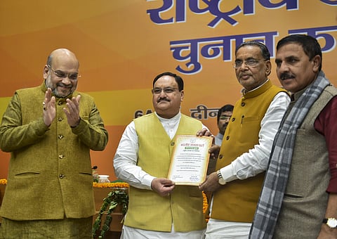 Outgoing BJP president Amit Shah claps as Organisation Poll process incharge Radha Mohan Singh hands over the victory certificate to party leader J P Nadda after he was elected as the next national president of the party in New Delhi Monday Jan. 20 2020.