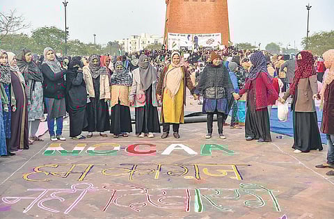Muslim women stage a protest against CAA and NRC near Ghantaghar in old city area of Lucknow on Monday. (Photo | PTI)