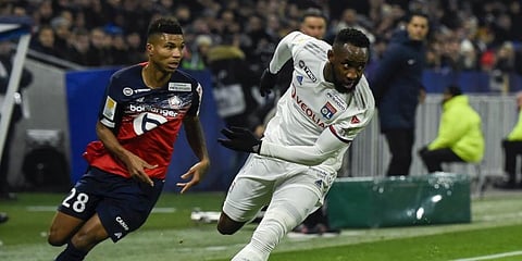 Lille's Mozambicans forward Reinildo Mandava (L) fights for the ball with Lyon's French forward Moussa Dembele during the French League Cup semifinal football match between Olympique Lyonnais and Lille LOSC at the Groupama stadium in Decines-Charpieu near