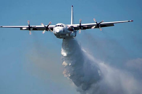 A C-130 Hercules plane drops water during a flight in Australia. (File Photo | AP)