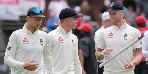England's captain Joe Root, left, Ollie Pope and Ben Stokes, right, leave the field of play after winning the third cricket test between South Africa and England in Port Elizabeth. (Photo | AP)
