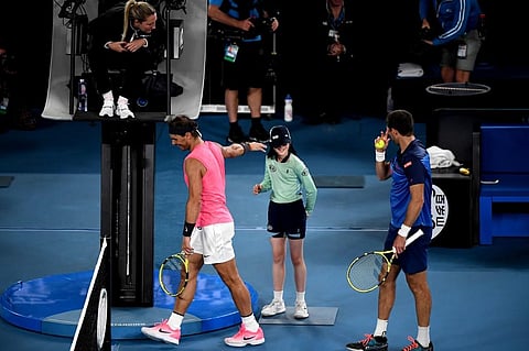 Spain's Rafael Nadal speaks with a ball kid who was hit by the ball during the men's singles match against Argentina's Federico Delbonis on day four of the Australian Open tennis tournament in Melbourne. (Photo | AFP)