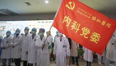 Medical workers of the Union Hospital with the Tongji Medical College of the Huazhong University of Science and Technology in Wuhan participate in a ceremony to form an 'assault team' to battle against a coronavirus epidemic in Wuhan in central China's Hu
