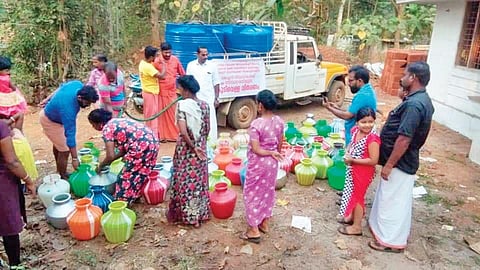 Seva Bharathi members supplying water to the people who were allegedly denied water at Cherukkunu Colony in Kuttippuram panchayat. (Photo | EPS)
