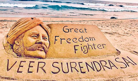 Sand artist Sudarshan Pattnaik pays tribute to freedom fighter Veer Surendra Sai through his sculpture in Puri on Thursday. (Photo| EPS)