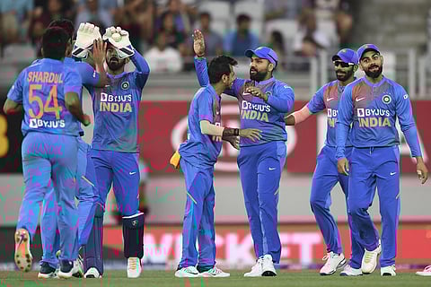 Rohit Sharma celebrates with teammates after taking a catch to dismiss New Zealand's Martin Guptill. (Photo | AP)