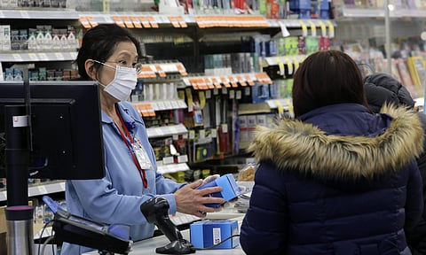 A sales clerk at a pharmacy rings up a purchase of face masks as fears of the coronavirus continues. (A sales clerk at a pharmacy rings up a purchase of face masks as fears of the coronavirus continues. (Photo | AP)