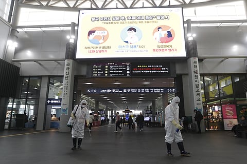 Employees work to prevent a new coronavirus as a screen warming about Wuhan coronavirus at Suseo Station in Seoul, South Korea, Friday, Jan. 24, 2020. (Photo | AP)