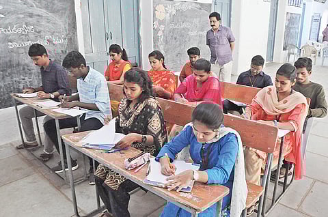 Students taking part in essay writing competition organised in Vijayawada on Friday on the occasion of National Voters’ Day. I EXPRESS