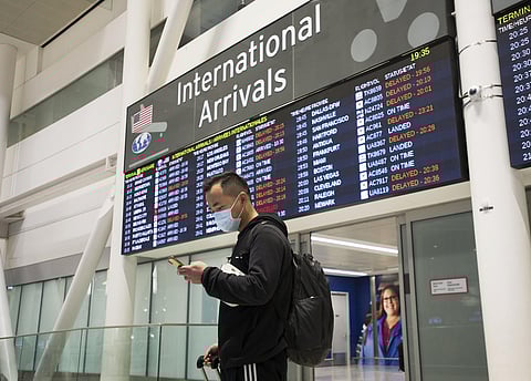 A man wears a masks following the outbreak of a new virus as people arrive from the International terminal at Toronto Pearson International Airport in Toronto on Saturday, Jan. 25, 2020. (Photo | AP)