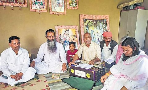 Ramzan Khan (centre), father of BHU Sanskrit professor Firoz Khan, whose appointment has triggered protests, with locals at his residence in Jaipur | PTI
