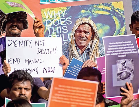 Protesters demand that the government enforce the ban on manual scavenging during a protest at Town Hall in Bengaluru on Monday | Pandarinath B
