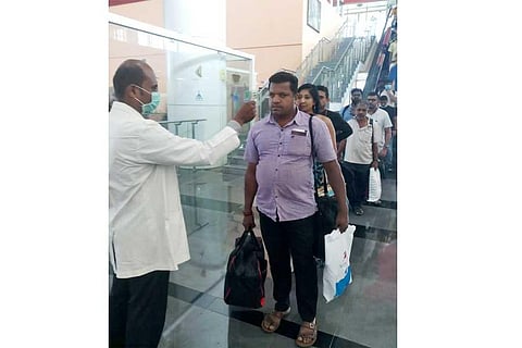 Health officials screening passengers at the Coimbatore International Airport.