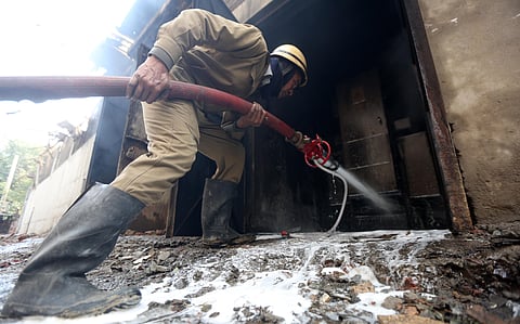 Firemen try to douse fire after a factory manufacturing batteries caught fire and collapsed in Peera Garhi area in New Delhi on Thursday. (Photo | EPS/Shekhar Yadv)