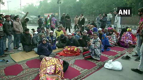 Protesters continue to sit outside Police Headquarters(old) at ITO against the firing incident in Jamia area yesterday in Delhi. (Photo | ANI twitter)