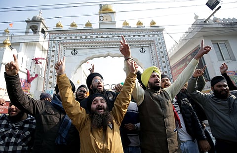 Sikh people raise slogans during a protest against the Pakistan government over the attack on Gurdwara Nankana Sahib. (Photo | ANI)